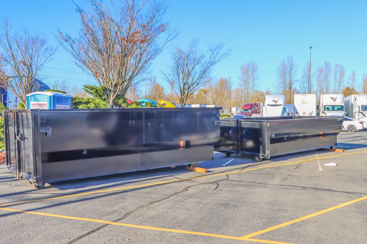 Professional dumpster rental service with roll-off container on residential driveway in Marvin